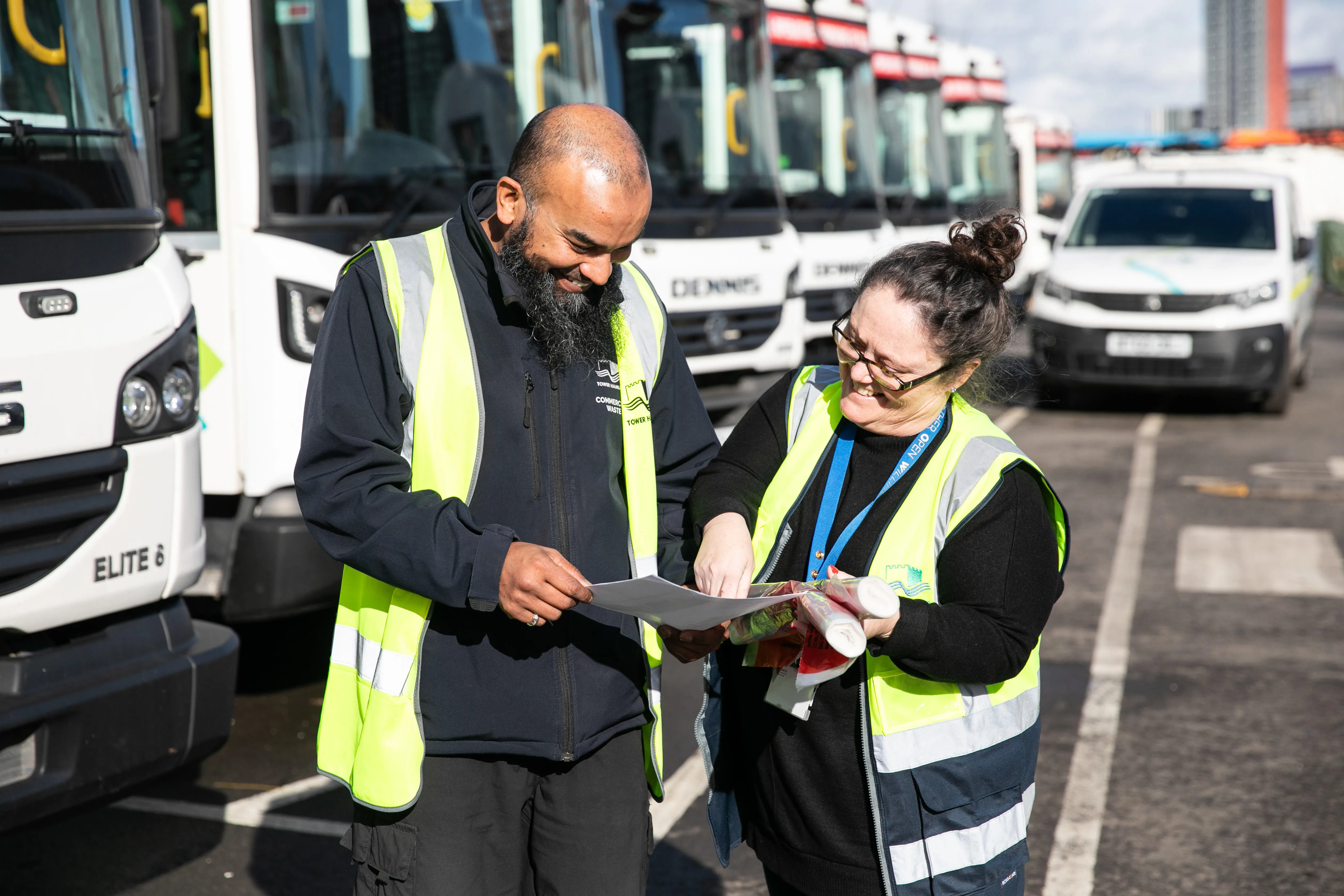Two waste officers working together at the waste depot.